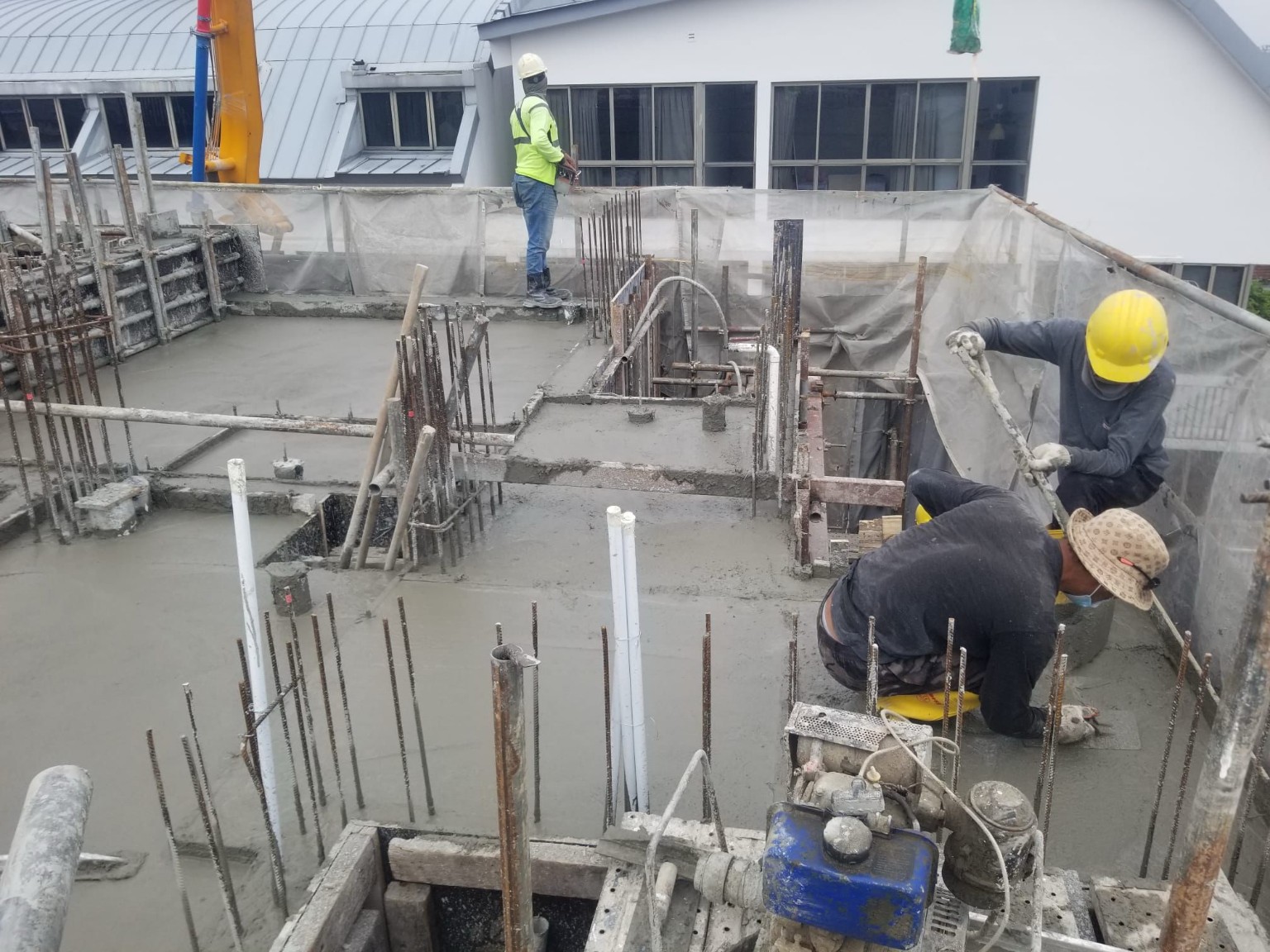 Workers carrying out reinforced concrete works on site